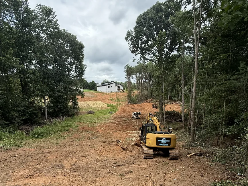Excavator and skid steer clearing a residential homesite in the Hickory, NC area — Platinum Construction & Crane